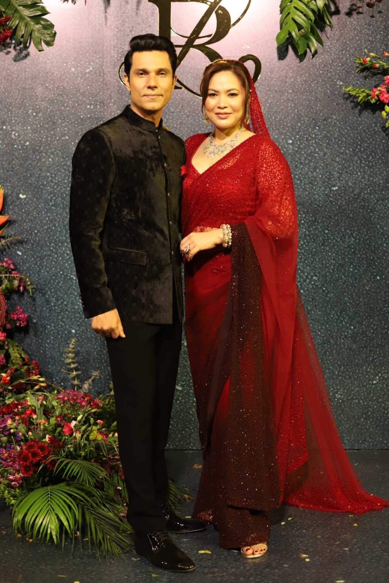 For the reception, new bride Lin Laishram wore a stunning red and brown gradient saree. She completed her look with stunning diamond jewellery. Meanwhile, Randeep Hooda complimented his wife in a black tuxedo. (Pic/Yogen Shah)